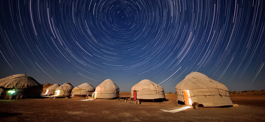 night sky over gobi desert mongolia with stars above ger camp ovago