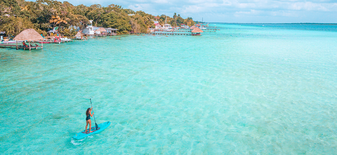 paddleboarding clear turquoise water tropical lagoon
