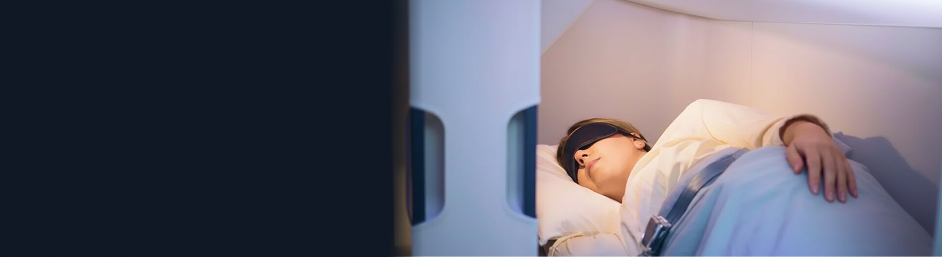 passenger sleeping in airplane bunk bed