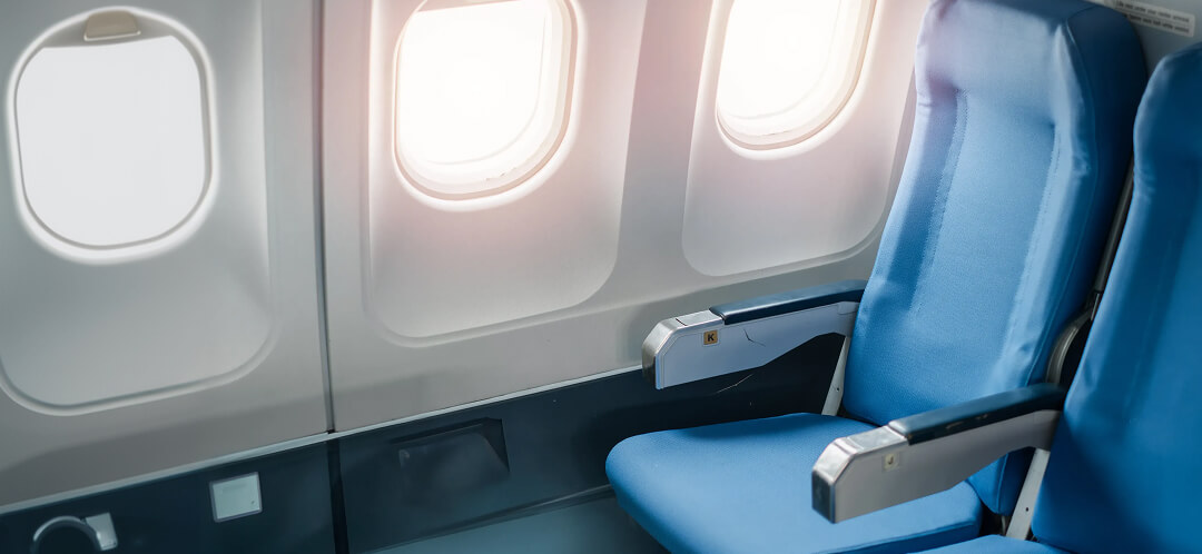 empty economy seat by airplane window