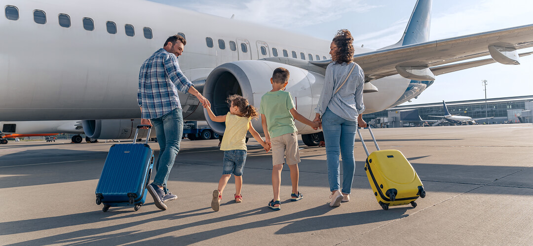 family boarding flight for summer vacation