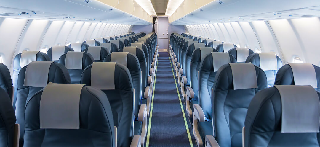 rows of economy class seats inside aircraft cabin
