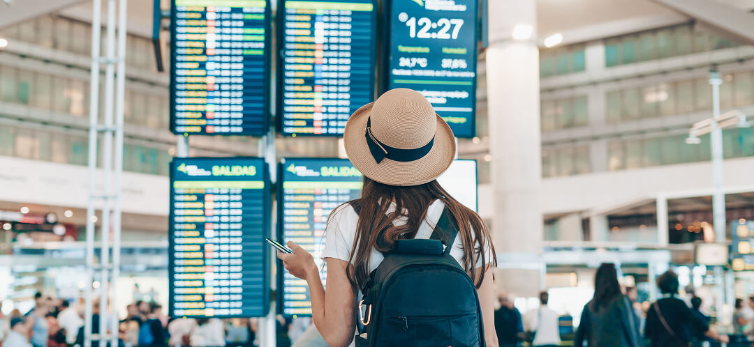 traveler checking airport departure board