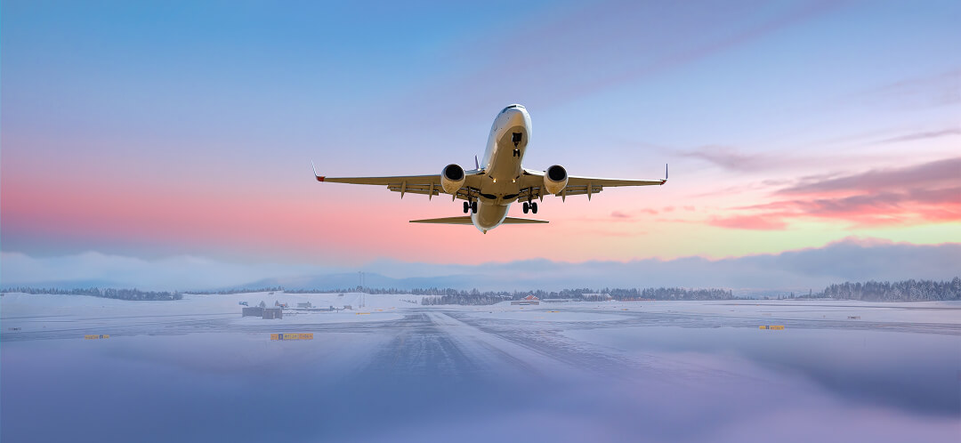 airplane taking off at sunset